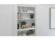 White built-in shelves display decorative objects and plants at 3300 Founding Place, Raleigh, NC 27612