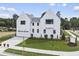 White two-story home with attached garage and landscaped yard at 3300 Founding Place, Raleigh, NC 27612