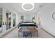 Bright bedroom with a king-size bed, French doors, and a sitting area at 3300 Founding Place, Raleigh, NC 27612