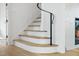 Modern staircase with a curved handrail and light wood steps at 3300 Founding Place, Raleigh, NC 27612