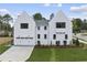 White two-story home with attached garage and landscaped yard at 3300 Founding Place, Raleigh, NC 27612