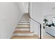 Modern staircase with light wood treads and a dark metal railing at 3300 Founding Place, Raleigh, NC 27612