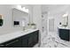 Elegant bathroom with dark vanity, marble floors, and a soaking tub at 3300 Founding Place, Raleigh, NC 27612