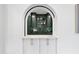 Elegant wet bar with arched alcove and dark green cabinetry at 3300 Founding Place, Raleigh, NC 27612