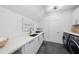 Modern laundry room with white cabinets, quartz countertops, and a large sink at 3300 Founding Place, Raleigh, NC 27612