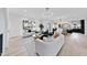 Open living room with hardwood floors, stylish sofas, and a view into the kitchen at 3300 Founding Place, Raleigh, NC 27612
