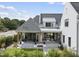 Spacious back patio with seating area and landscaping, attached to a two story home at 3300 Founding Place, Raleigh, NC 27612