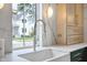 Modern kitchen sink with a sleek, white farmhouse sink and a chrome gooseneck faucet at 3300 Founding Place, Raleigh, NC 27612