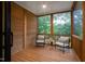 Relaxing screened porch with wooden floors and comfortable seating at 2119 Brewer St, Raleigh, NC 27608