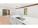 Modern kitchen island with white quartz countertop and stainless steel sink at 2123 Brewer St, Raleigh, NC 27608