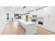 Modern kitchen with white cabinets, large island, and stainless steel appliances at 2123 Brewer St, Raleigh, NC 27608