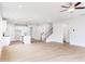 Spacious living area with wood-look flooring, recessed lighting, and open staircase at 7412 Prato Ct, Wendell, NC 27591