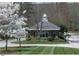 Gated community entrance with guard house and landscaping at 56708 Nash, Chapel Hill, NC 27517