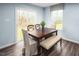 Bright dining area with wooden table, bench, and sliding glass door to backyard at 524 Camaro Rift Trl, Wendell, NC 27591