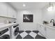 Well-appointed laundry room with modern washer, dryer, and cabinets at 2009 St Marys St, Raleigh, NC 27608