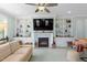 Living room with built-in shelving, fireplace, and large TV at 427 Cliffdale Rd, Chapel Hill, NC 27516