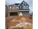 Two-story home with brick and blue siding, a large garage, and a spacious front yard at 200 Berry Mill Ln # 153, Raleigh, NC 27603