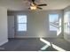 Spacious bedroom with carpet, ceiling fan and large windows at 386 Fast Pitch Ln, Four Oaks, NC 27524