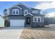 Two-story house with gray siding, stone accents, and a two-car garage at 386 Fast Pitch Ln, Four Oaks, NC 27524