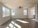 Spacious living room with hardwood floors and large windows at 386 Fast Pitch Ln, Four Oaks, NC 27524