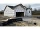 New construction home exterior; wrapped in house wrap, two-car garage at 472 Barbour Farm Ln, Four Oaks, NC 27524