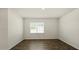 Simple bedroom with hardwood floors and window with blinds at 226 Moore Creek Dr, Fuquay Varina, NC 27526
