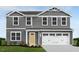 Two-story gray house with white accents and a two-car garage at 1577 Ivy Meadow Ln, Zebulon, NC 27597
