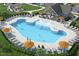 Relaxing community pool with plenty of lounge chairs and umbrellas at 1577 Ivy Meadow Ln, Zebulon, NC 27597