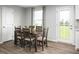 Bright dining area with a wooden table and chairs near sliding doors at 1577 Ivy Meadow Ln, Zebulon, NC 27597