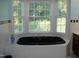 Bathroom with large corner bathtub and window at 334 Ira B Tart Rd, Dunn, NC 28334
