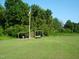 Wooded area with grassy field and storage shed at 334 Ira B Tart Rd, Dunn, NC 28334