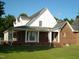 Brick and white sided home with a wraparound porch at 334 Ira B Tart Rd, Dunn, NC 28334
