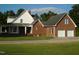 Brick home with attached two-car garage and circular driveway at 334 Ira B Tart Rd, Dunn, NC 28334