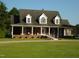 Brick home with wraparound porch and landscaped yard at 334 Ira B Tart Rd, Dunn, NC 28334