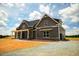 Gray farmhouse-style home with a gravel driveway and large yard at 6030 Preacher Hayes Rd, Mebane, NC 27302