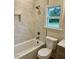 Bathroom with bathtub, toilet and marble tile at 6030 Preacher Hayes Rd, Mebane, NC 27302