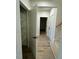 Hallway with built-in shelving, additional rooms, and hardwood floors at 6030 Preacher Hayes Rd, Mebane, NC 27302