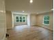 Spacious bedroom with hardwood floors and multiple windows at 6030 Preacher Hayes Rd, Mebane, NC 27302