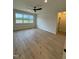 Spacious bedroom with hardwood floors, large windows, and ceiling fan at 6030 Preacher Hayes Rd, Mebane, NC 27302