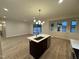 Modern kitchen with island, stainless steel appliances, and hardwood floors at 6030 Preacher Hayes Rd, Mebane, NC 27302