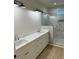 Double vanity bathroom with a large shower and marble tile at 6030 Preacher Hayes Rd, Mebane, NC 27302