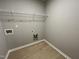 Laundry room with wire shelving and built-in storage at 68 Oakfield Trace Dr, Four Oaks, NC 27524