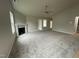 Spacious living room with fireplace and carpet flooring at 68 Oakfield Trace Dr, Four Oaks, NC 27524