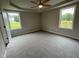 Bright bedroom featuring two windows and wall-to-wall carpet at 83 Oakfield Trace Dr, Four Oaks, NC 27524