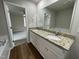 Double vanity bathroom with granite countertops and a garden tub at 83 Oakfield Trace Dr, Four Oaks, NC 27524