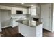 Modern kitchen with granite countertops, stainless steel appliances, and white cabinets at 83 Oakfield Trace Dr, Four Oaks, NC 27524