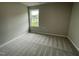 Bright bedroom with neutral carpeting and a window at 83 Oakfield Trace Dr, Four Oaks, NC 27524