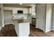 Modern kitchen with granite countertops, stainless steel appliances, and white cabinets at 83 Oakfield Trace Dr, Four Oaks, NC 27524