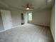 Spacious bedroom with plush carpeting and an ensuite bathroom at 83 Oakfield Trace Dr, Four Oaks, NC 27524