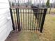 Black metal gate provides secure access to the fenced backyard at 51 Autumn Gate St, Pittsboro, NC 27312